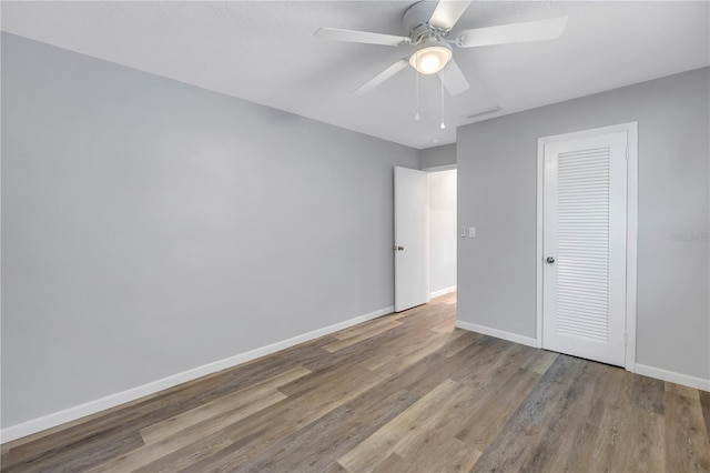 unfurnished bedroom with ceiling fan, light hardwood / wood-style floors, and a closet