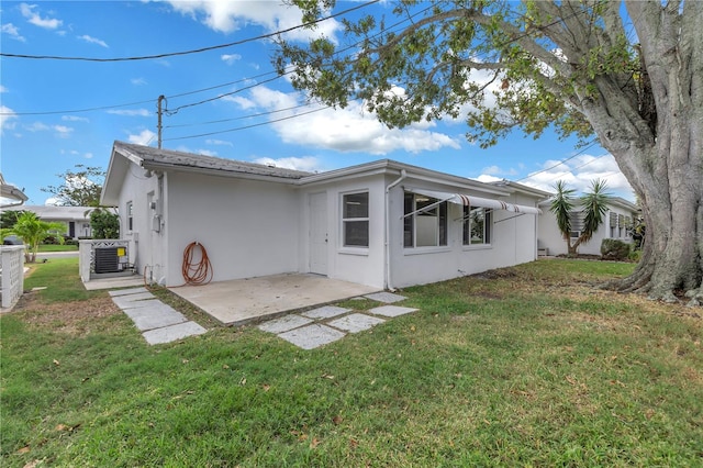 back of property with a patio area and a lawn