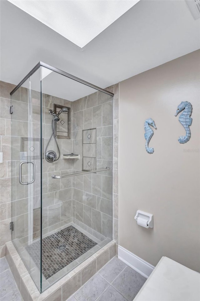 bathroom with tile patterned floors and a shower with shower door