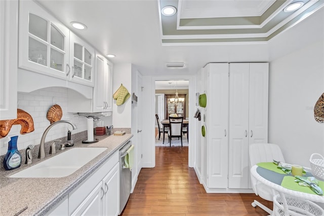 kitchen featuring white cabinets, dishwasher, light hardwood / wood-style floors, and sink