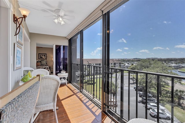 sunroom featuring ceiling fan