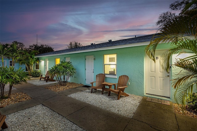 back house at dusk with a patio