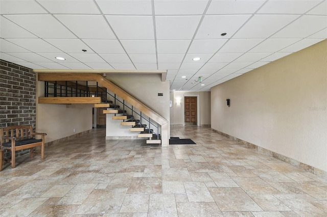 basement with a paneled ceiling