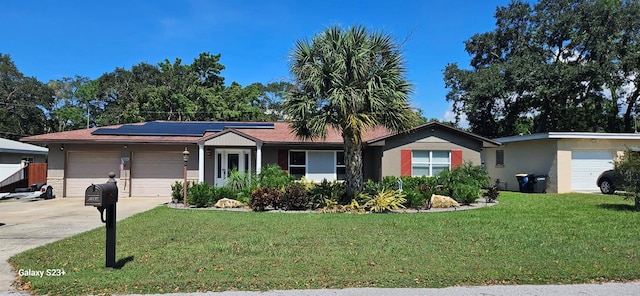 single story home featuring a front lawn, solar panels, and a garage