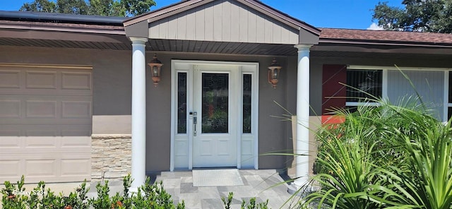 view of exterior entry featuring a garage