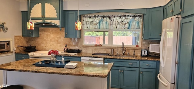 kitchen featuring backsplash, dark stone countertops, white appliances, and sink