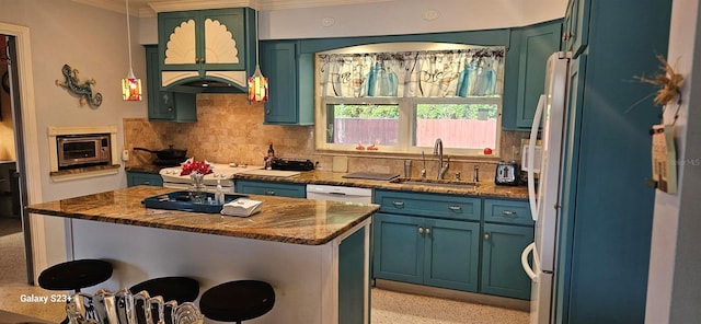 kitchen featuring sink, backsplash, a center island, stainless steel range, and crown molding