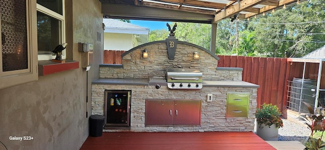 view of patio featuring area for grilling, grilling area, and a wooden deck