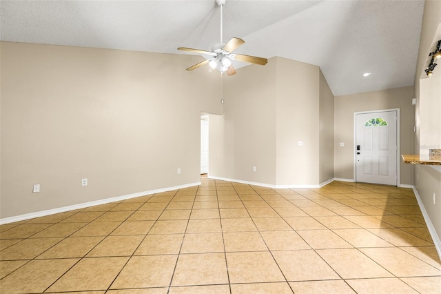 interior space featuring a textured ceiling, ceiling fan, and light tile patterned floors