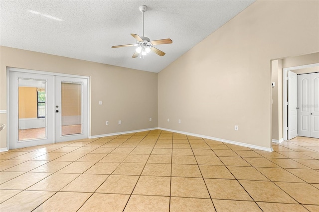 tiled empty room with ceiling fan, french doors, lofted ceiling, and a textured ceiling