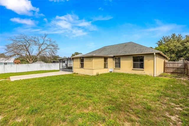 back of property featuring a yard