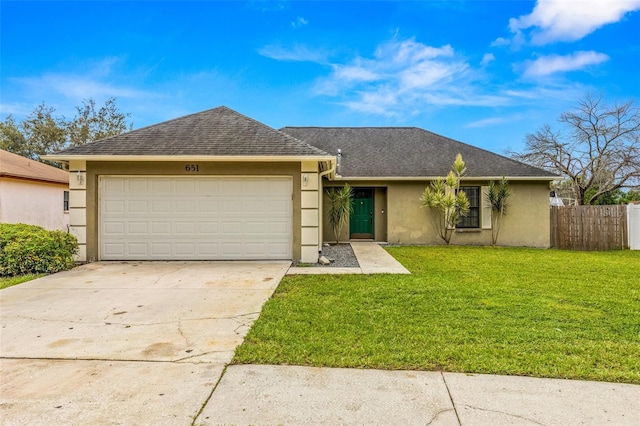 ranch-style home featuring a front yard and a garage