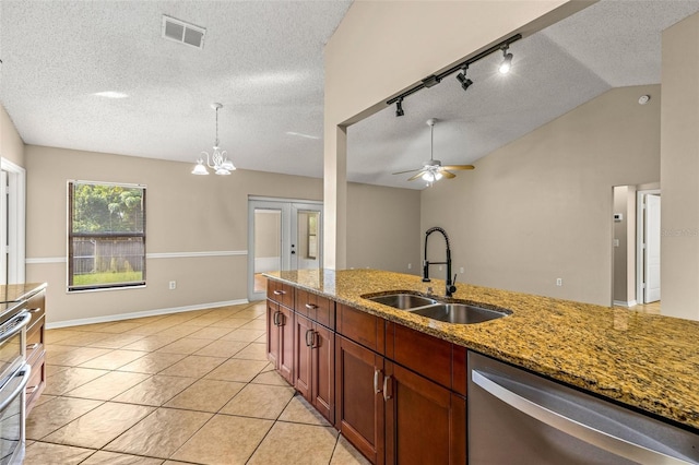 kitchen featuring dishwasher, light stone counters, sink, lofted ceiling, and ceiling fan with notable chandelier