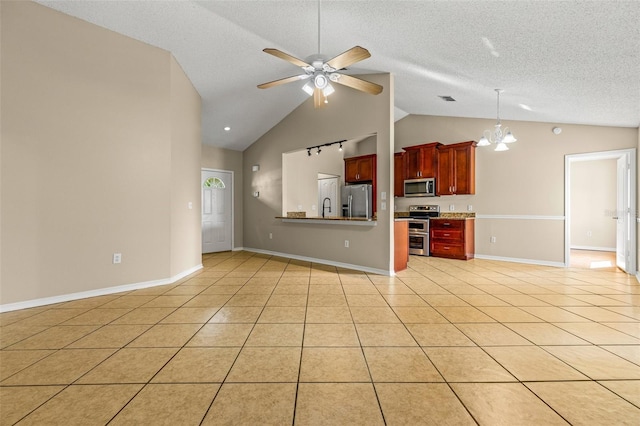 kitchen featuring stainless steel appliances, hanging light fixtures, sink, light tile patterned flooring, and ceiling fan with notable chandelier