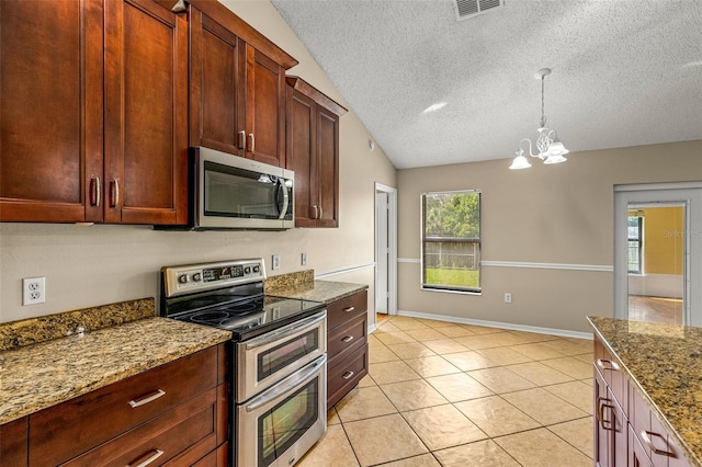 kitchen with appliances with stainless steel finishes, light tile patterned floors, light stone counters, an inviting chandelier, and lofted ceiling