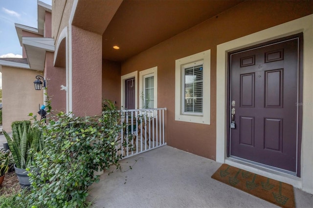 doorway to property featuring covered porch