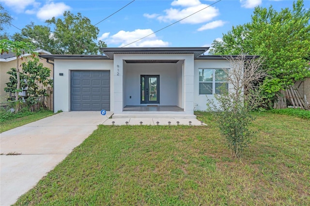 view of front of home with a front yard and a garage