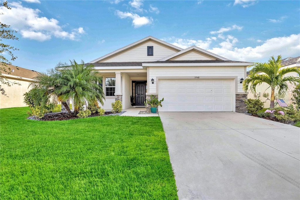 view of front of home with a garage and a front lawn