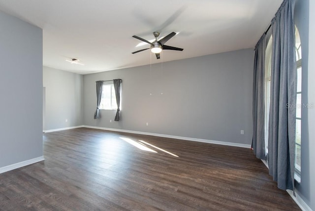 unfurnished room with dark hardwood / wood-style flooring and ceiling fan