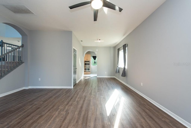 unfurnished living room featuring dark hardwood / wood-style floors and ceiling fan