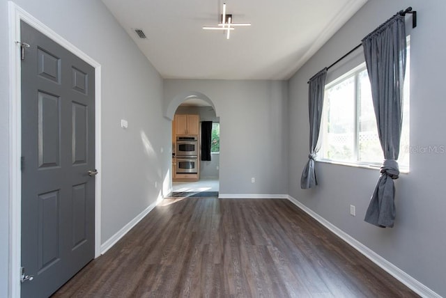 unfurnished room featuring dark wood-type flooring