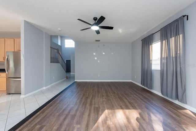 unfurnished living room featuring ceiling fan and light hardwood / wood-style floors