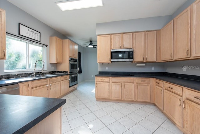 kitchen featuring sink, light brown cabinets, appliances with stainless steel finishes, light tile patterned floors, and ceiling fan