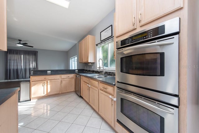 kitchen featuring light brown cabinets, light tile patterned flooring, sink, and stainless steel appliances