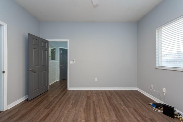 spare room featuring dark hardwood / wood-style flooring