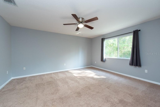 carpeted empty room featuring ceiling fan