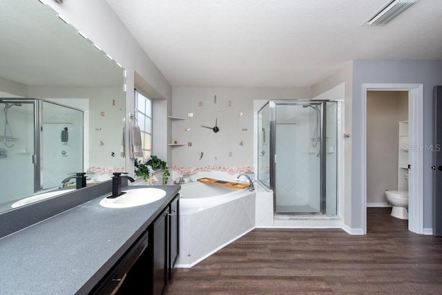 full bathroom featuring independent shower and bath, toilet, vanity, and hardwood / wood-style floors