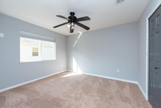 carpeted empty room featuring ceiling fan