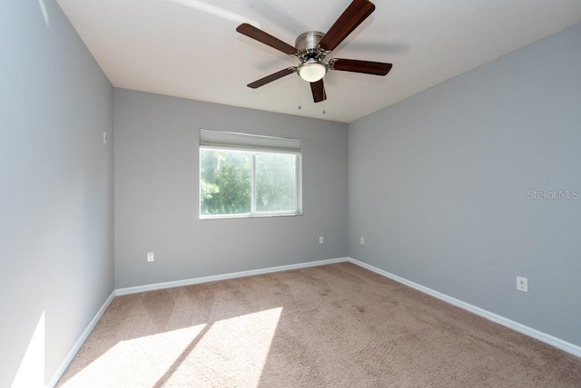 carpeted empty room with ceiling fan