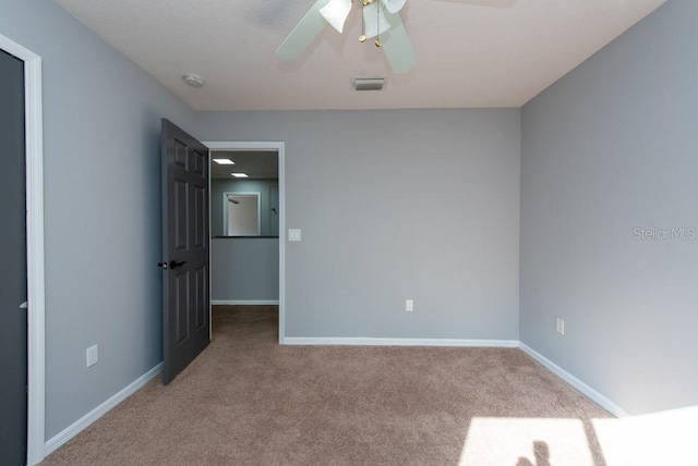 spare room featuring ceiling fan and light colored carpet