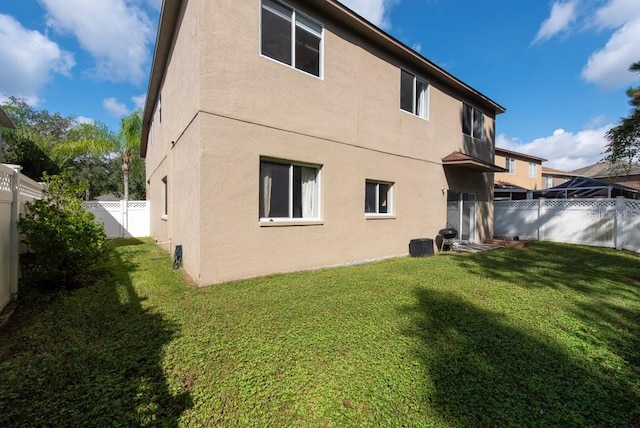 rear view of property featuring a yard