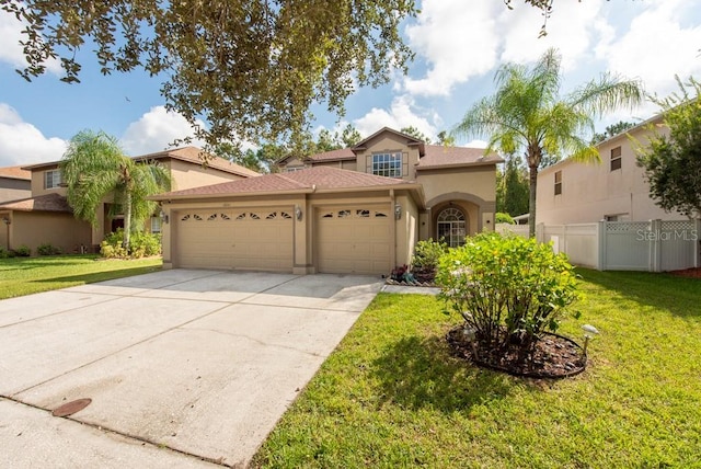 mediterranean / spanish house with a front yard and a garage