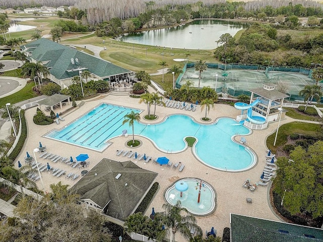 view of pool with a patio and a water view