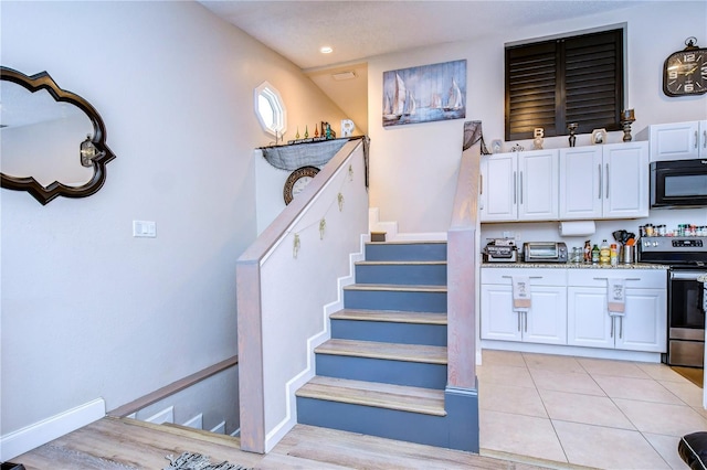 staircase featuring tile patterned floors