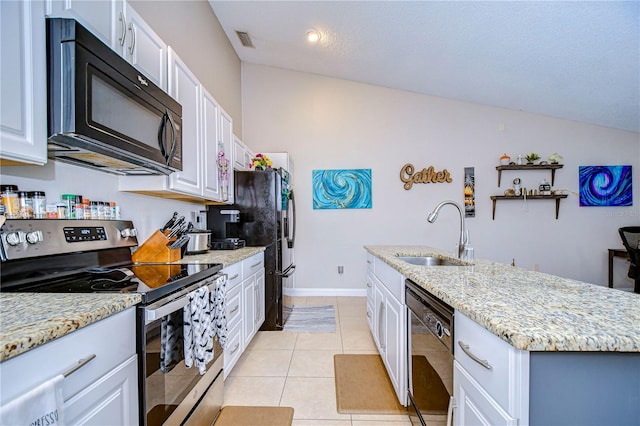 kitchen with lofted ceiling, white cabinets, and black appliances