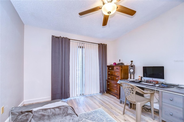 office space featuring light hardwood / wood-style flooring, a textured ceiling, and ceiling fan