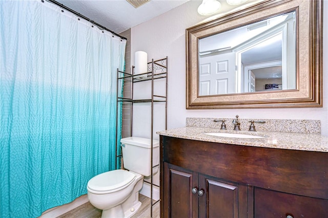 bathroom featuring vanity, toilet, a textured ceiling, walk in shower, and hardwood / wood-style floors