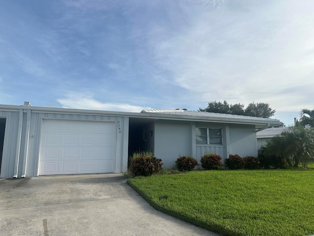 ranch-style house featuring a garage and a front yard