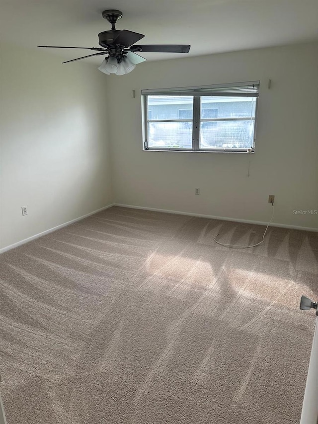 unfurnished room featuring carpet and ceiling fan