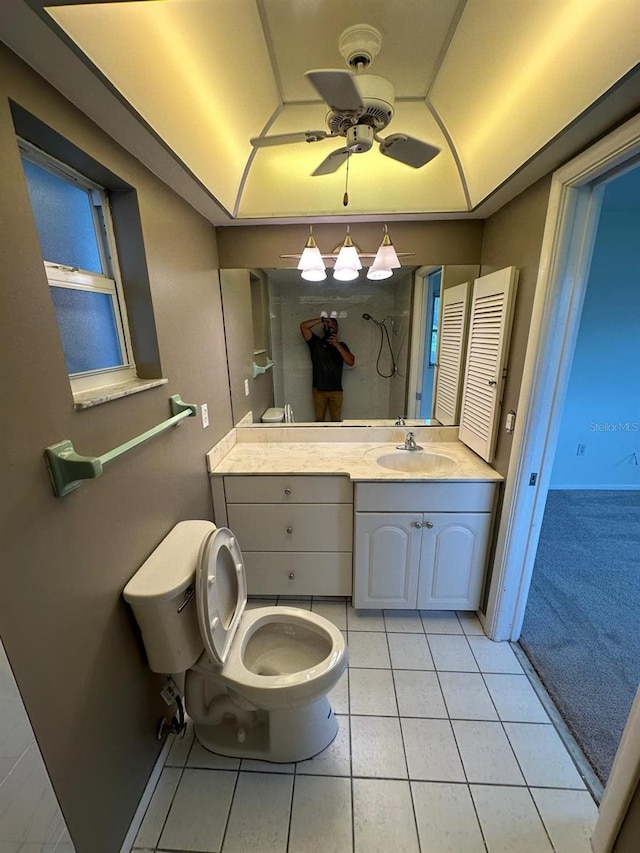 bathroom featuring ceiling fan, vanity, tile patterned flooring, and toilet