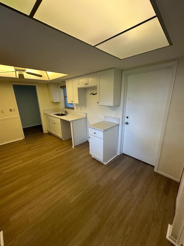 kitchen featuring white cabinets, sink, and dark hardwood / wood-style flooring