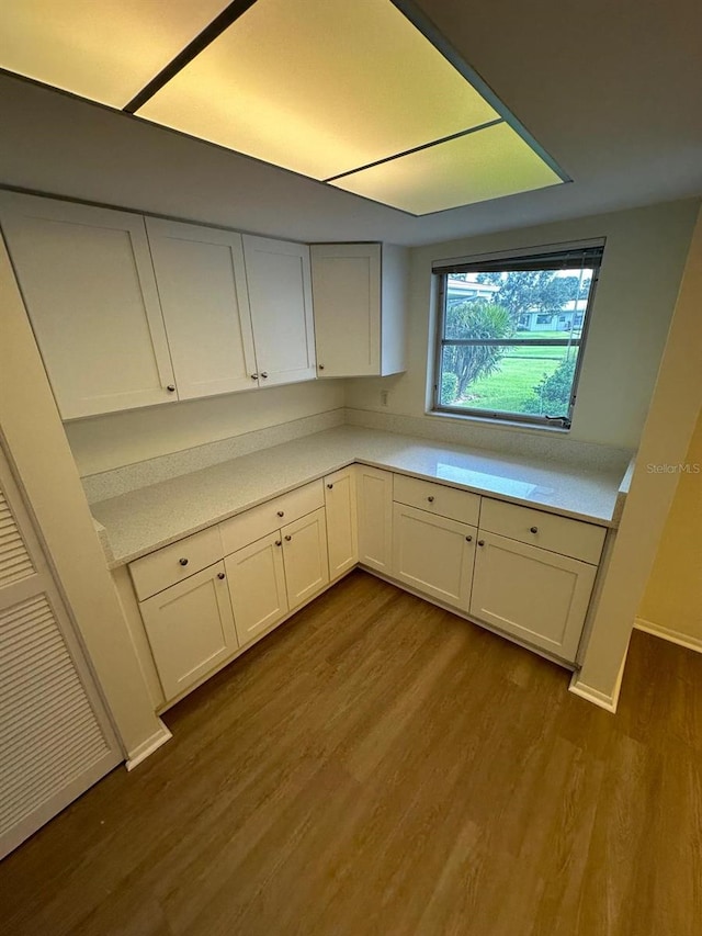 kitchen with white cabinets and light wood-type flooring