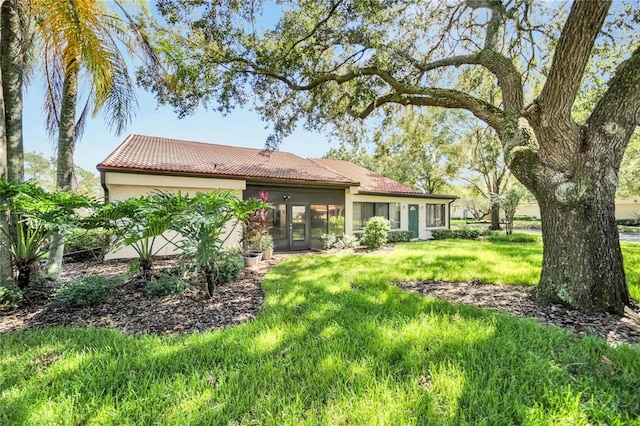 rear view of house with a yard