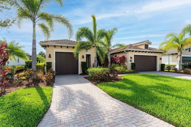 view of front of house featuring a front yard and a garage