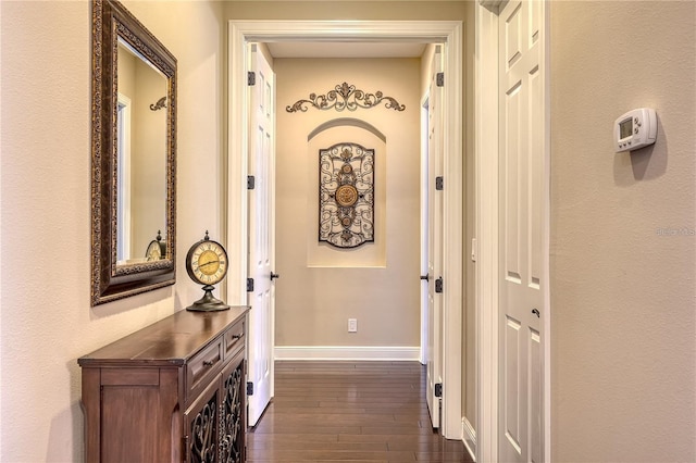 hall with dark wood-type flooring