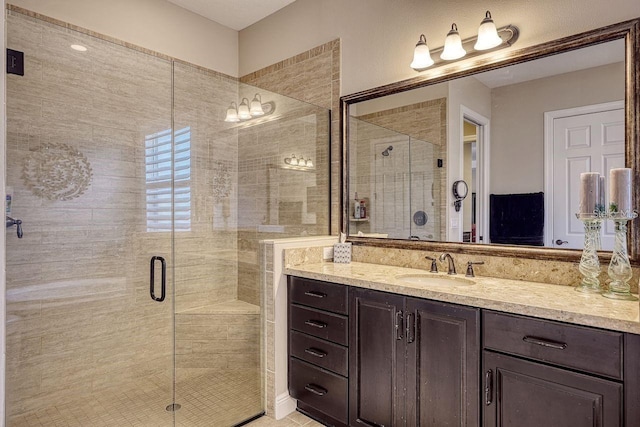 bathroom featuring vanity and an enclosed shower